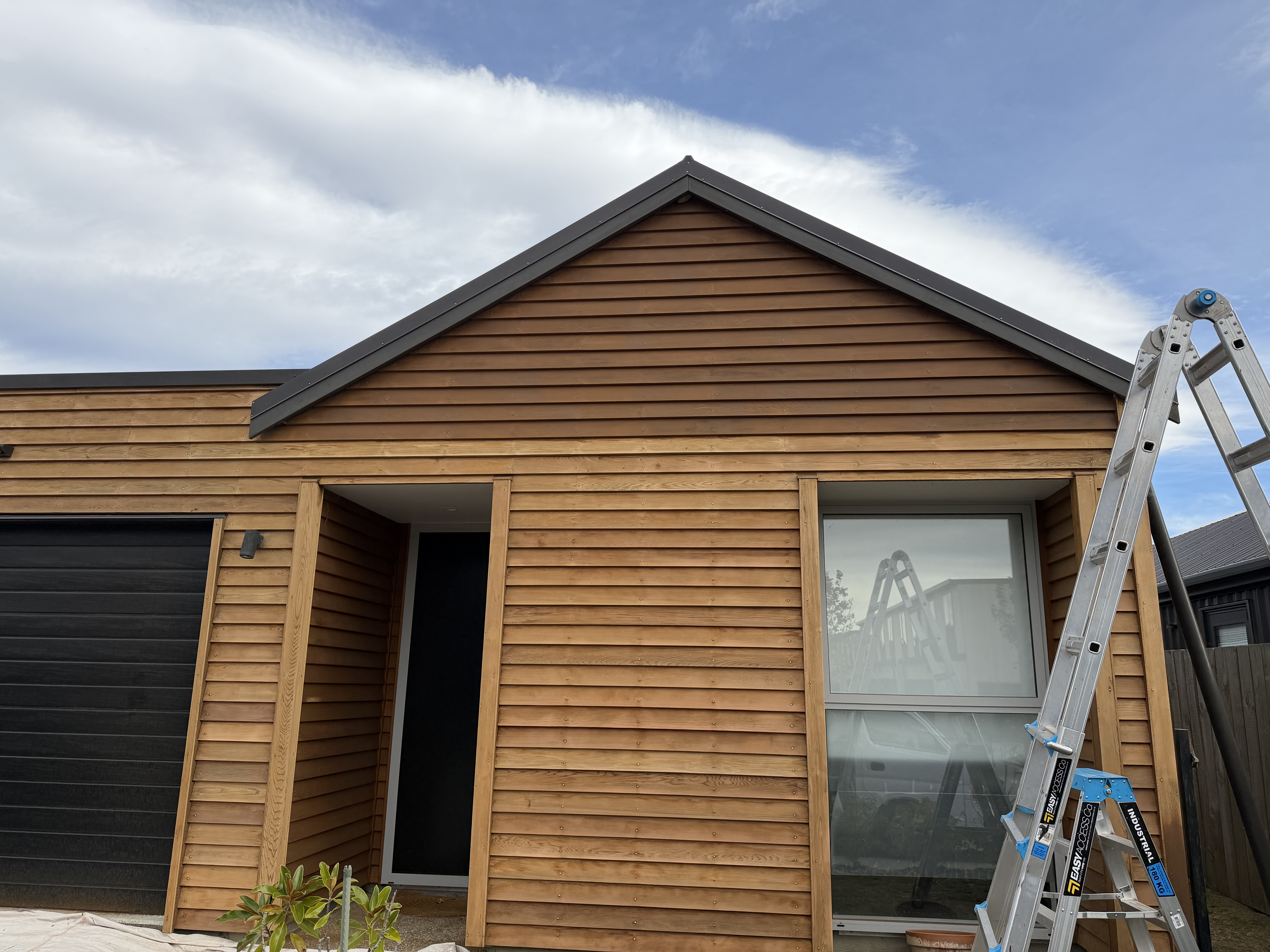 Cedar Maintenance in Northlake, Wānaka - Process 4: Front Elevation Sanded Cedar Mid Staining Northlake Wanaka.Webp